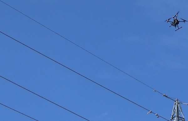 [A drone inspecting transmission lines] 